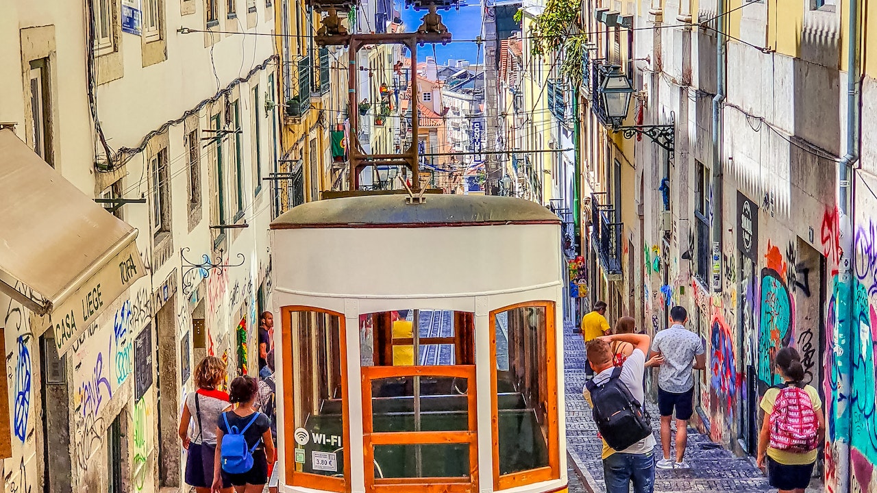 People Walking on Street Near Yellow Tram