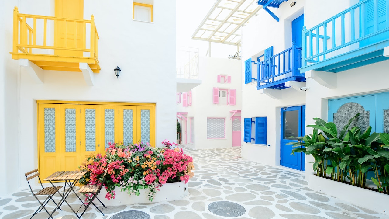 Architectural Photography of Three Pink, Blue, and Yellow Buildings